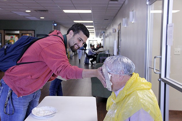 Students take a break to pie their professors