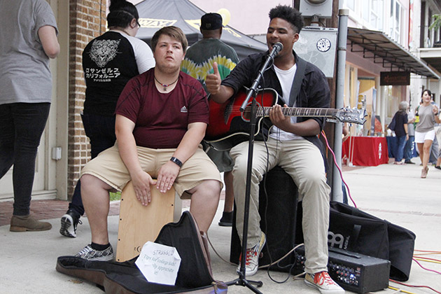 Musician Nathaniel Bauerle, right, performs on the streets of Hammond during the 2017 “Hot August Night.” 