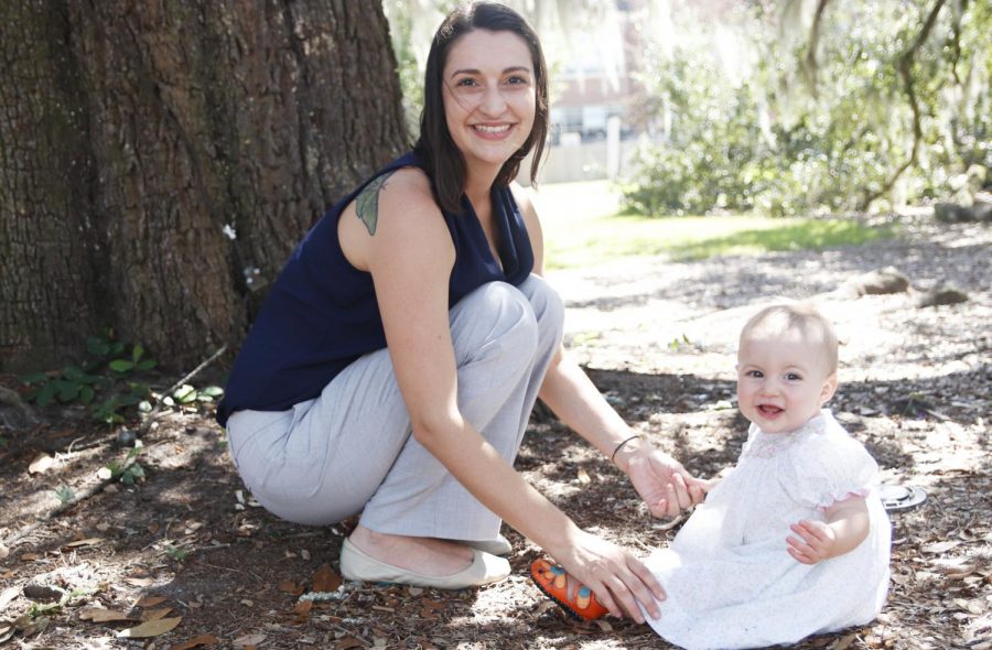 Alaina Fontenot, a junior early childhood education, PK-3 major, sits with her daughter Luna Fontenot underneath Friendship Oak. Alaina Fontenot has been sober from her addiction to alcohol and pills for four years.