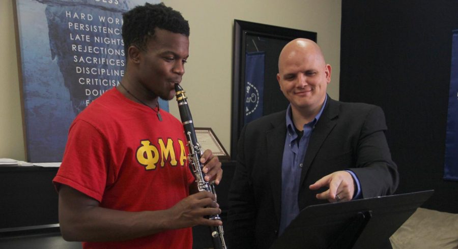 Instructor of Clarinet and Assistant Director of Bands Victor Drescher shows a Phi Mu Alpha student the proper clarinet technique. Drescher has taught at the university since 2013. 