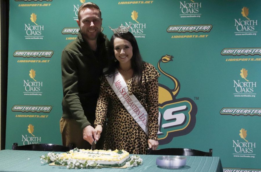 Alyssa Larose, a junior elementary education and special education major,  cuts the cake with Coordinator of Campus Activities Board Nick Elliott, celebrating her time as Miss Southeastern.