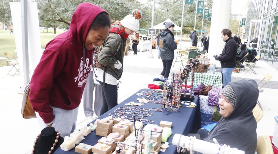 Iyania McClendon, a freshman kinesiology major, checks out wares at Reconnects farmers market. 