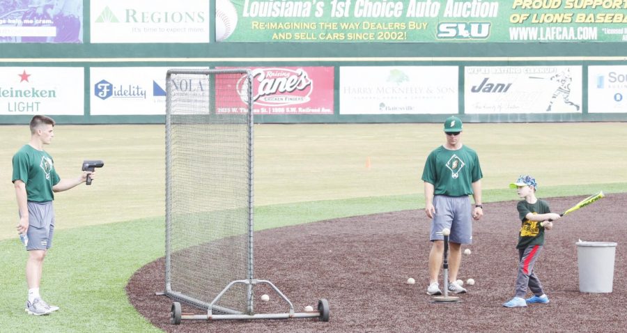 Father and son pairs participated in baseballs first Father/Son Camp to practice drills and tour athletic facilities.