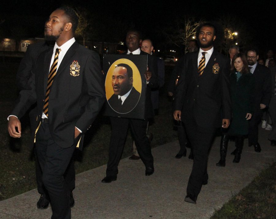 Members of Alpha Phi Alpha Fraternity Inc. lead a memorial program for Dr. Martin Luther King Jr. The program began with a march at 6 p.m. followed by a gathering in the University Center.