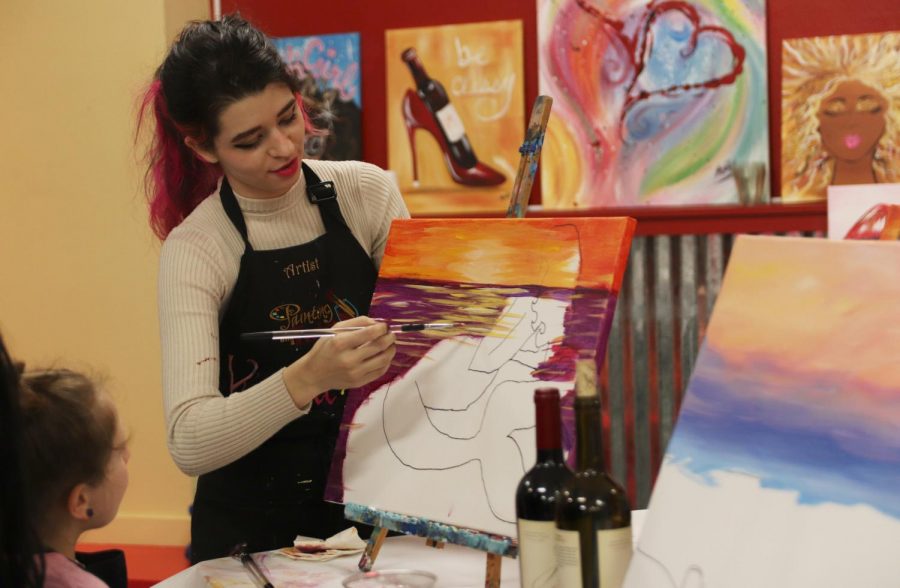 Kendall Alvis, an instructor at Painting with a Twist, teaches a class on painting a mermaid and a beach scene. Along with the Hammond Regional Arts Center and the Columbia Theatre for the Performing Arts, Painting with a Twist is a venue in Hammond that can mingle romance and art. 