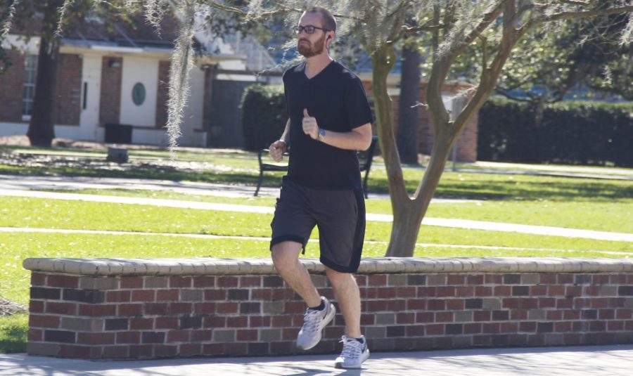 Andrew Belgard, a senior chemistry major, goes for an afternoon run in Friendship Circle. Exercise like running can boost mood due to an increase in endorphin levels along with the muscle workout. 