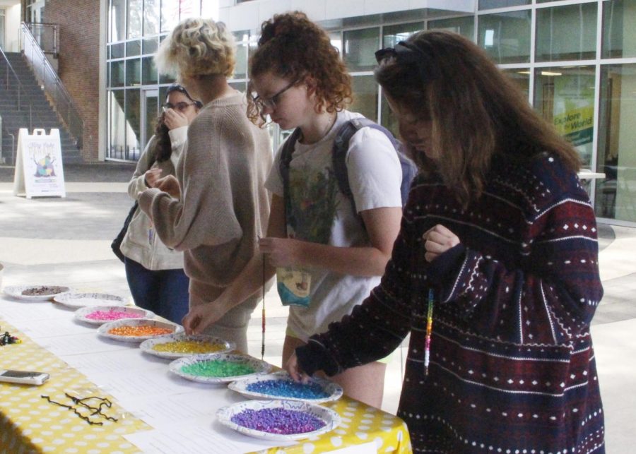 Students put beads on a string in association with privileges. The Southeastern Sociological Association held Privilege Pendants in the Student Union Breezeway on Feb. 27. 