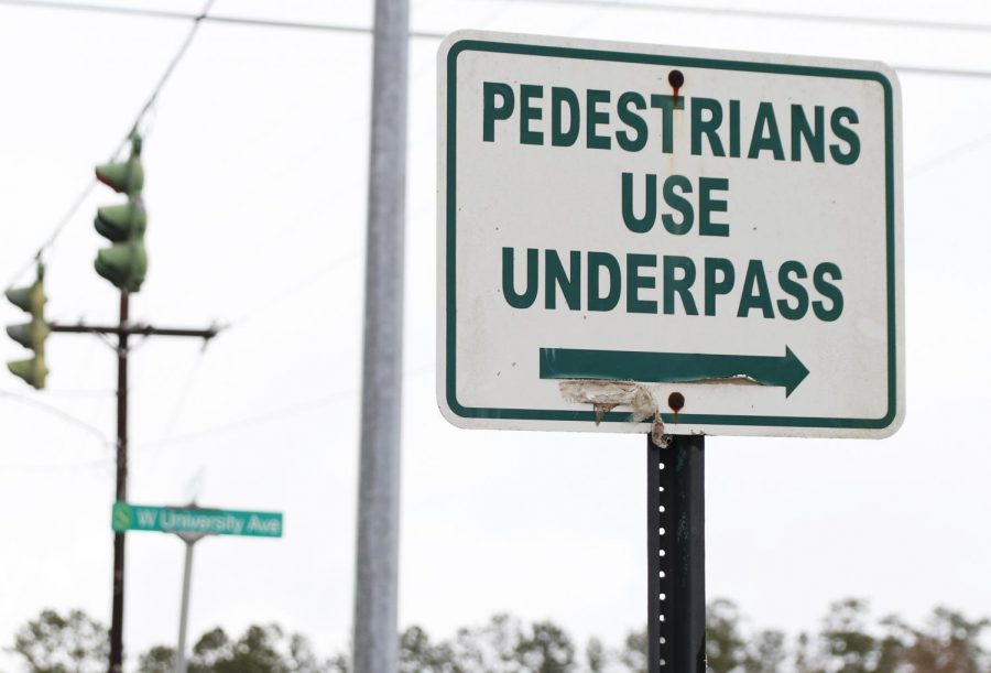 A sign on the corner of N General Pershing St. and W University Ave. directs pedestrians to utilize the underpass since there is not an established crosswalk running across W University Ave. University police have ticketed pedestrians for not abiding by this rule. 