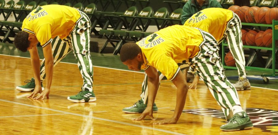 The men’s basketball team stretches to warm up before the game against Sam Houston State University. Athletes are commonly viewed as role models to both athletes and non-athletes alike. 