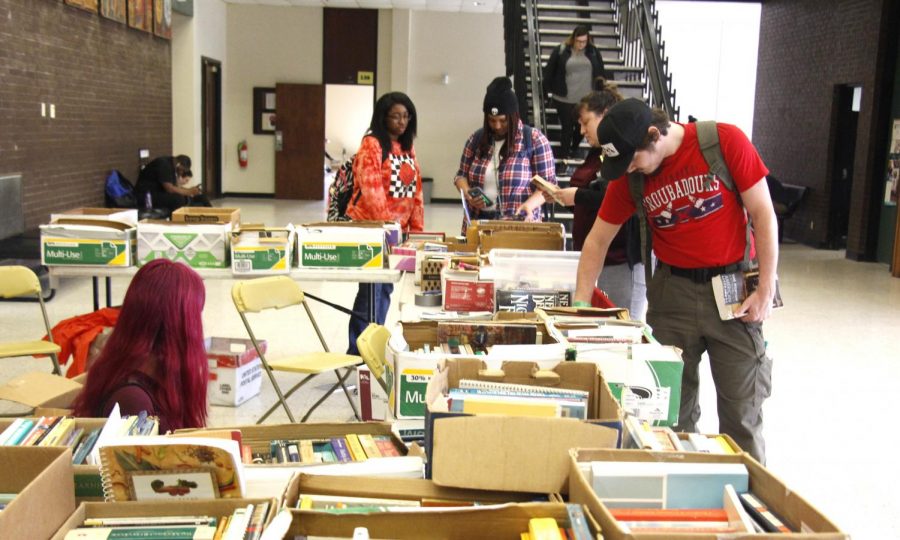 Students browse through the selection of books Tuesday afternoon. The Sigma Tau Delta book sale will be held from Mar. 12-13.