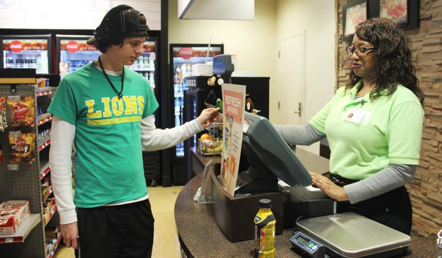 Evan McCann, a freshman information technology major, purchases food from Yolander Henderson in the Student Union Market. Lion’s Lagniappe can be used on and off campus whereas Cub Cash only works on campus. 