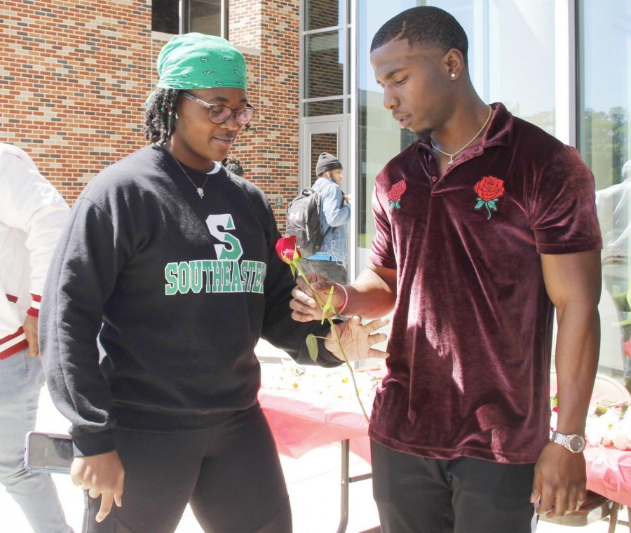Members of Kappa Alpha Psi Fraternity, Inc. handed out roses and treats to women passing by in honor of Womens History Month. 