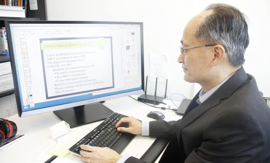 Dr. Quoc-Nam Tran, head of the Department of Computer Science, prepares a PowerPoint presentation about the importance of the computer science major for incoming freshmen. The university’s Department of Computer Science graduates the most computer science students in the state. 