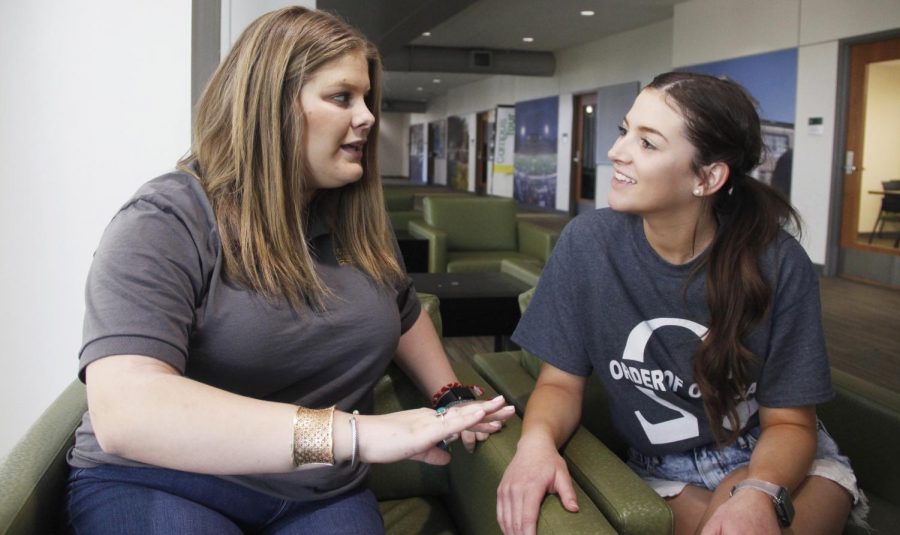 Ali Leto, a freshman biological sciences major and chapter secretary of Alpha Omicron Pi, speaks with Taylor Mangus, a senior nursing major and president of Order of Omega, about Greek Week. 