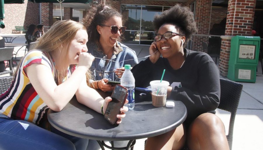 Victoria Wade, a freshman biological sciences major, left, Abigail Street, a junior English major, middle, and Karin Perry, a freshman criminal justice major, right, listen to music through earphones. All three appreciate gospel music. 