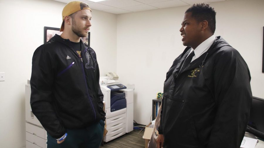 Johannes “Joey” Verhaegh, a graduate assistant for Multicultural and International Student Affairs and a former member of the Lions football team, left, speaks with Richard Davis Jr., president of the Student Government Association, right. From their position in the public, athletes can find their voices bringing attention to political topics. 
