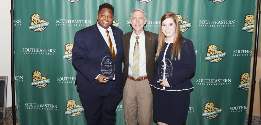 During DSA convocation, Richard Davis Jr., a senior middle school education major, left, was named 2019 Man of the Year, and Karley Bordelon, a junior social studies major, right, was named 2019 Woman of the Year.  The two honorees pose with Dr. John L. Crain, university president.
