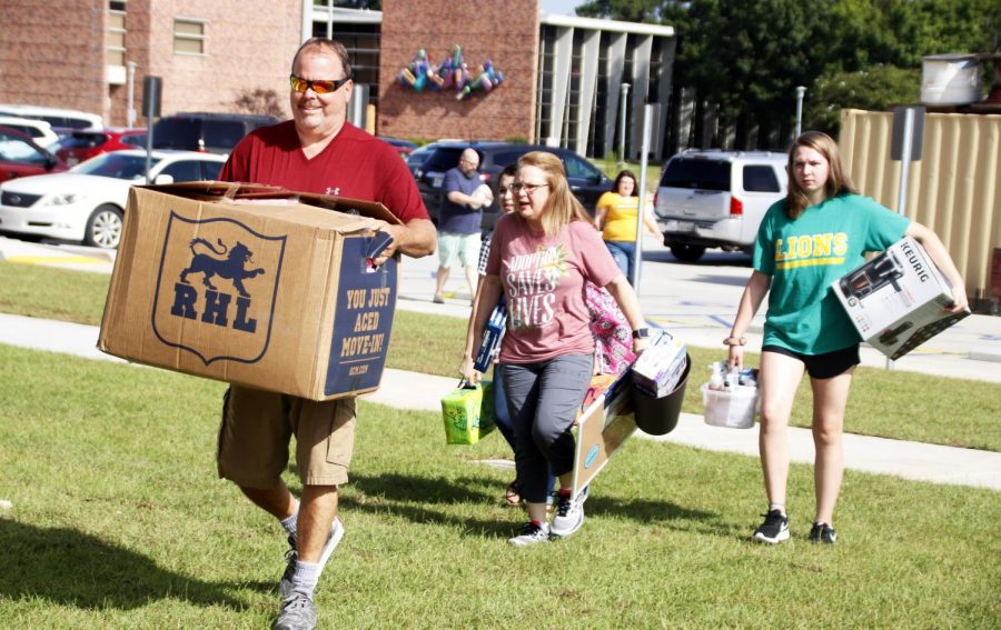 Students and their family carry boxes into the dorms during Move in Mania. Knowing what you do and do not need for college is crucial before going off to live on your own.
