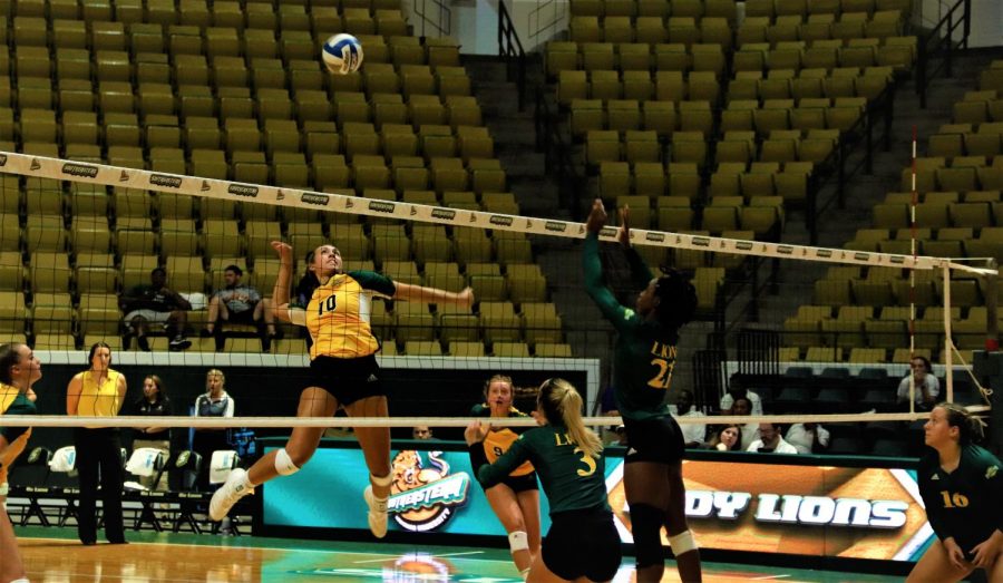 During the second set, Sam Gomez, a junior middle blocker, jumps up to spike the ball while Hannah Barosh, a junior outside hitter/defensive specialist, Jodi Edo, a senior middle blocker, and Ariana Hebert, a freshman setter, get prepared to defend. The Gold team won the second set 25-21.