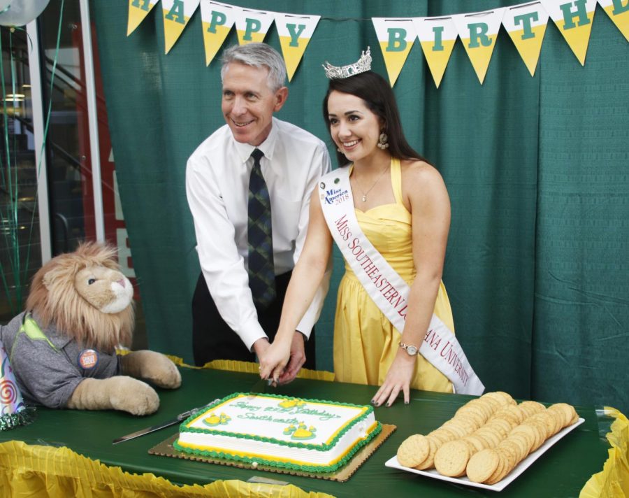 Dr.+John+Crain%2C+president+of+the+university%2C+cuts+cake+with+Miss+Southeastern+2018+Alyssa+Larose+during+the+university+birthday+celebration+organized+by+the+Campus+Activities+Board.+The+institution+that+began+as+Hammond+Junior+College+in+1925+will+turn+94+this+year.