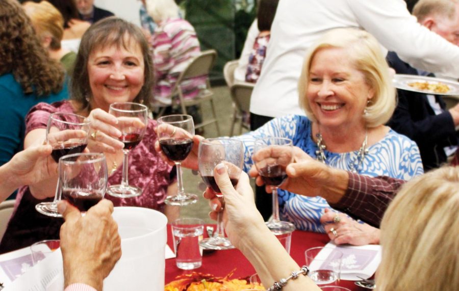 Participants enjoy during the wine-tasting event organized by the Friends of Sims Library. 