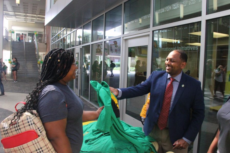 Dr. Eric Summers, vice president for student affairs, hands out T-shirts to students in the Student Union Breezeway. The university marked the beginning of Homecoming Week on Monday, Oct. 7. 