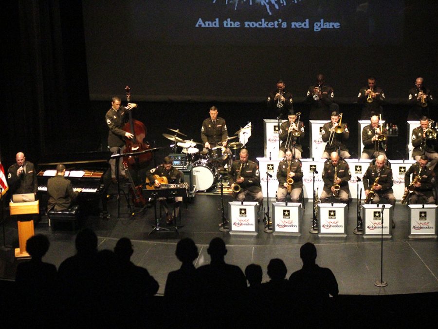 Audience members stand as the Jazz ambassadors of the U.S. Army field Band performs the national anthem. The orchestra played a selection of songs that reflected the hardships and highlights of World War II.