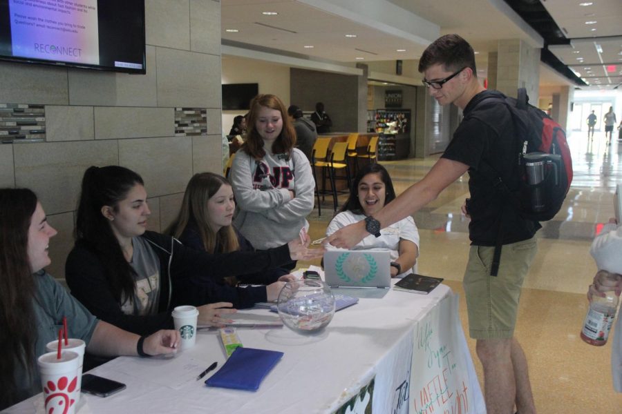 Members of Alpha Sigma Tau sell tickets for Waffle Night. The sorority raises fund for their philanthropy  Womens Wellness Initiative annually by organizing the event.