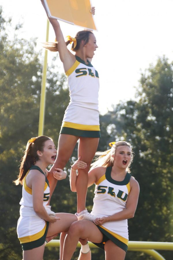 The university cheerleaders enagage crowd during a home game. The cheerleaders practice three times a week and started practicing in June for the fall semester. 