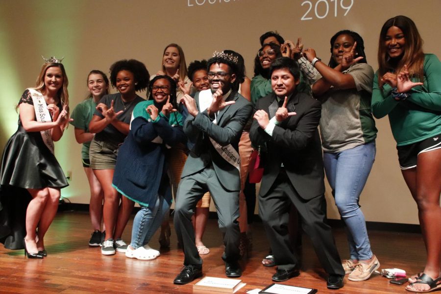 Brian Williams, a senior communication major, poses for a picture with Miss Southeastern Louisiana University 2019 Chelsey Blank and orientation leaders after winning the competition. Williams played musical instruments for his talent competition, and won the “Best Hair Award.“