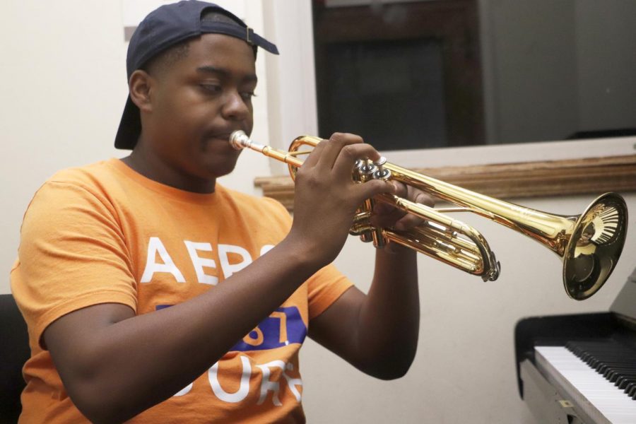 Brian White, a freshman music major, practices on the trumpet. Music majors must practice whenever they can to keep up with their instrument. 