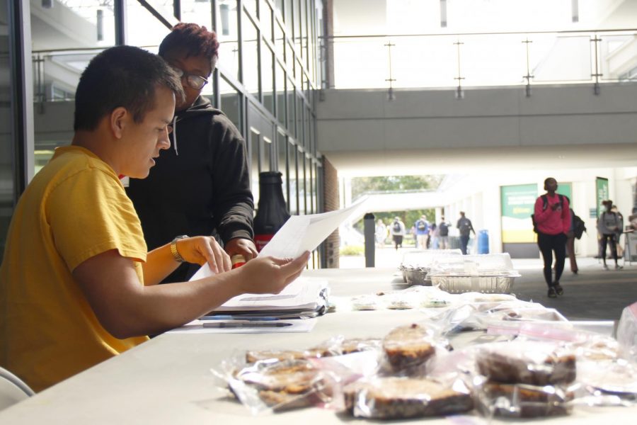 Jean Paul Templet, a sophomore biological sciences major, and Amanda Scott, a junior social work major, discuss their bake sale plans to raise money for their organization and spread awareness on mental illness.

