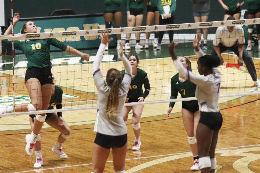 Sam+Gomez%2C+junior+middle+blocker%2C+jumps+to+spike+incoming+ball+during+set+against+Central+Arkansas.+The+Lady+Lions+lost+the+final+set%2C+causing+them+to+lose+the+match+2-3.+