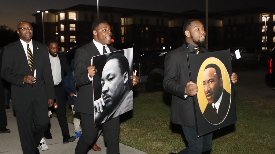 Bomani Brown, member of the Kappa Nu chapter Alpha Phi Alpha Fraternity, Inc., and Larry Banks, Vice President of the Kappa Nu chapter, lead the procession, carrying pictures of Dr. Martin Luther King Jr. The “Dr. Martin Luther King Jr. Memorial March & Program” took place on Monday, Jan. 27 at 6 p.m. The march started at the Pennington Student Activity Center and was followed by a presentation at the Student Union Theater. The guest speaker was Tyronne Walker, who serves as President of the Sigma Lambda Chapter of Alpha Phi Alpha Fraternity, Inc. 