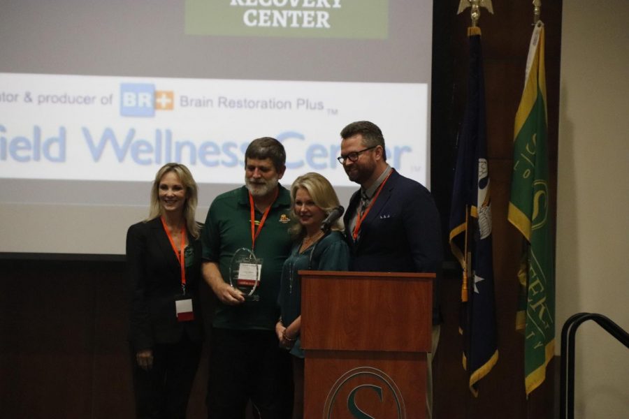 Paige Moody, Dr. Peter Emerson, Krystal Hardison and Tony Terrell take a picture together after Dr. Emerson won the award.