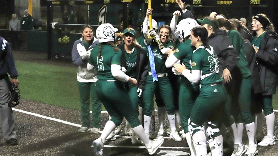 Karlee Kraft, a sophomore pitcher/utility player, is met by her team at home plate after she hit her first home run of the season against Alabama State University.