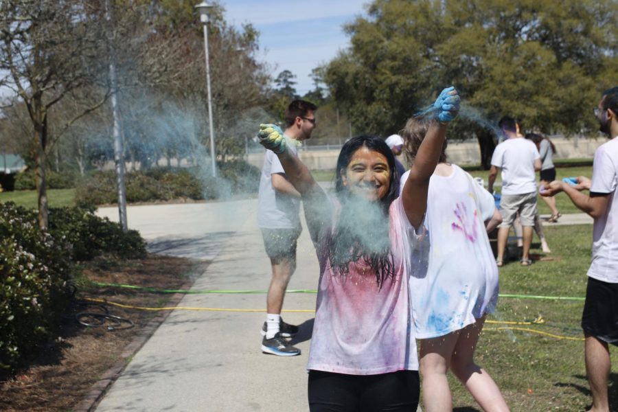 Dipika Ghimire, a junior nursing major, plays with color during Holiday festival organized by the Nepalese Students Association at Southeastern.