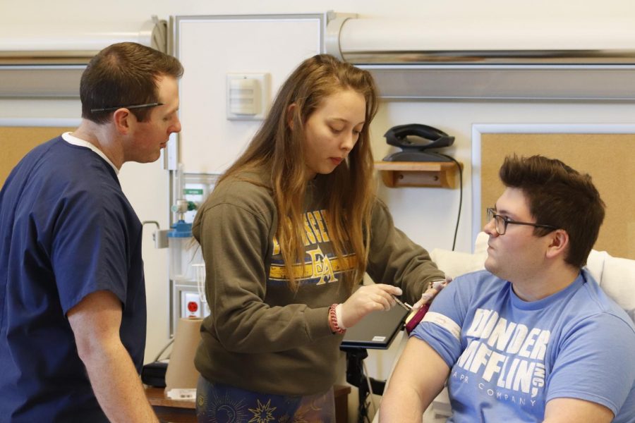 Sophomore Isabella Trinka practices injections on sophomore Austin McAndrew in nursing instructor Jamie Davis’s class. Nursing is known to have a rigorous and time-consuming curriculum. Students not only must take pre-requisite courses but are also required to complete clinicals, hands-on courses in which nursing majors learn, practice and are tested on their on-site skills.