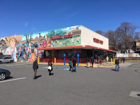 Customers at a Trader Joes in Cambridge, Massachusetts practice social distancing as they wait in line. Maintaining a six feet distance can help flatten the curve and reduce the spread of the coronavirus.
