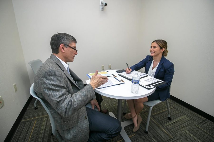 Sales professional Jeff Brown and senior marketing major Ashley Murphy participate in  the Spring 2020 Sales Competition in one of the role-play rooms that have recording technology. The Professional Sales Lab allows students and professors to review footage from the role-play rooms and give feedback.