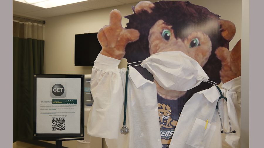 The Roomie poster in the University Health Center has a mask on. According to the university, as of Sept. 4, a total of 35 students tested positive for the novel coronavirus.  