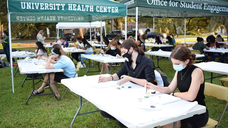 Students gather in Friendship Circle for the university’s “Brush Away Your Stress” painting event as a part of Homecoming Week. Participants were provided with canvases, paint, water and paint brushes. 