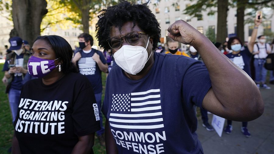 People gathered in Black Lives Matter Plaza, react to the presidential race being called in Joe Bidens favor, Saturday, Nov. 7, 2020, in Washington. Democrat Joe Biden has defeated President Donald Trump to become the 46th president of the United States.