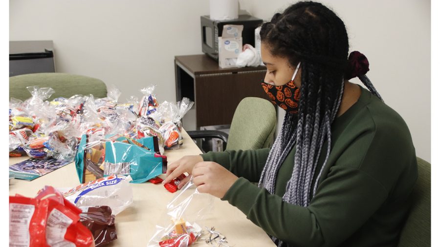 Student worker Frannie Reyes, junior psychology and criminal justice major, prepares goodie bags in the Office of Military
& Veteran Success. The office will have a table set up near the Student Union on Wednesday, Nov. 11 from 11 a.m.-3:30
p.m. to commemorate Veterans Day and hand out the goodie bags.