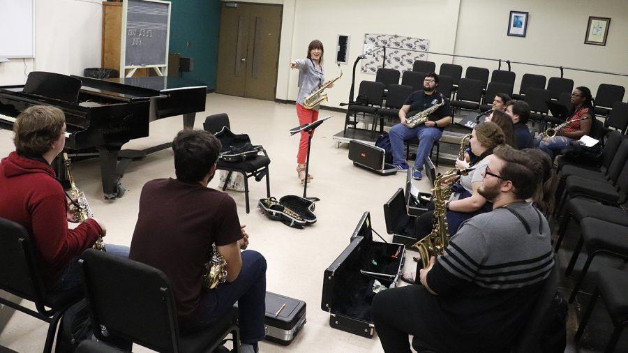 Instructor of saxophone Brina Bourliea Faciane points towards Billy Mizzell, a freshman music major, during lecture. One of the topics Bourliea Faciane covered was the position of the tongue when playing a saxophone.