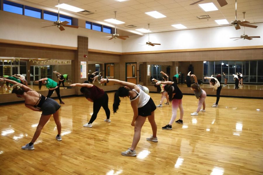 Guests stretch and exercise at the Mardi Gras Dance Party in Room 228 at the REC, hosted by dance fitness instructor Catherine Brasher, on Wednesday, Feb. 10 from 5:30-6:20 p.m.