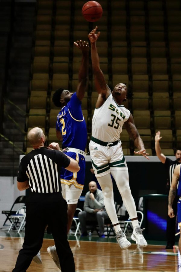 Junior guard/forward Gus Okafor reaches for the jump ball to start off the Lions home game against McNeese State University on Feb. 24. 