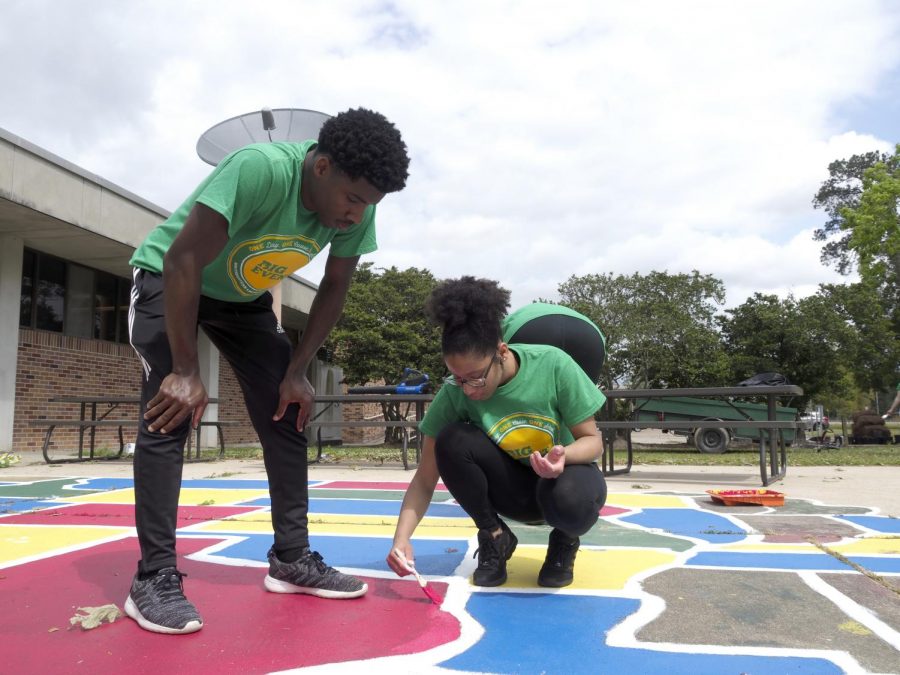 Volunteers from 2019s Big Event repaint a map of the United States in an elementary school courtyard. This year, rather than one day of volunteering, SGA is hosting an all week donation drive. 