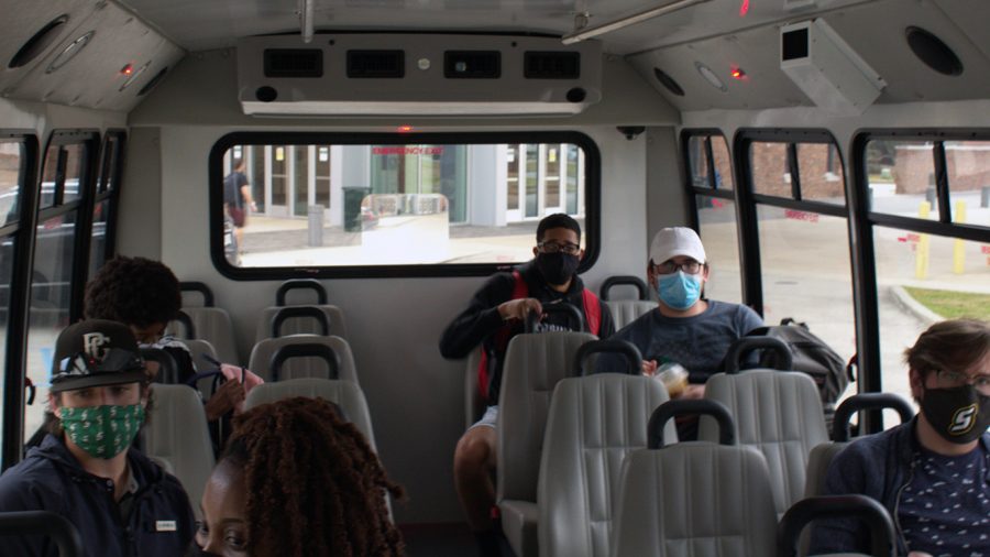 Students sit socially distanced on the Lion Traxx shuttle bus as they head to their next destination. In order to use university transportation, students are required to follow all safety protocols and regulations.