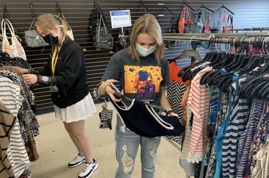 Freshman computer science major Abby Ortego looks through clothes at Goodwill. She is searching for professional clothes so that she can give a speech. 